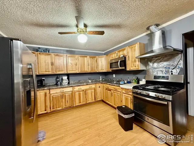 a kitchen with stainless steel appliances granite countertop a stove sink and cabinets