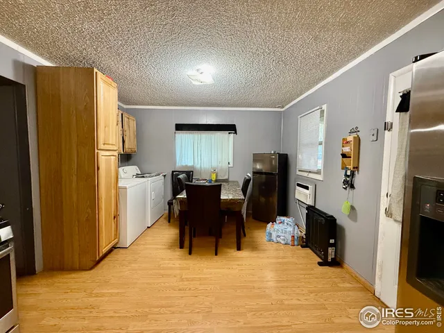 a view of a kitchen with refrigerator and dining table