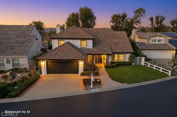 a front view of a house with a garden and yard