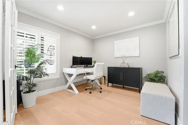 a view of a workspace with furniture and a potted plant