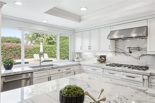 a kitchen with a stove a sink and a cabinets