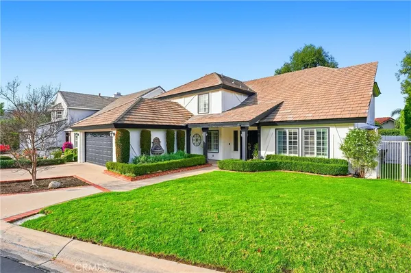 a front view of a house with a yard and porch