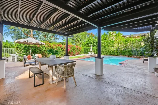 a patio with a table and chairs