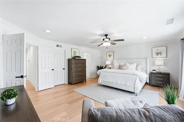 a spacious bedroom with a bed and a couch