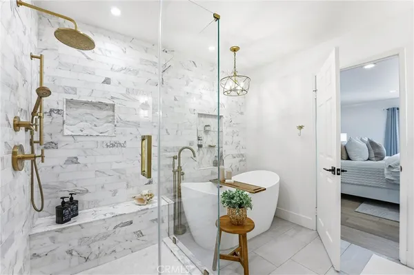 a bathroom with a granite countertop sink a toilet and shower