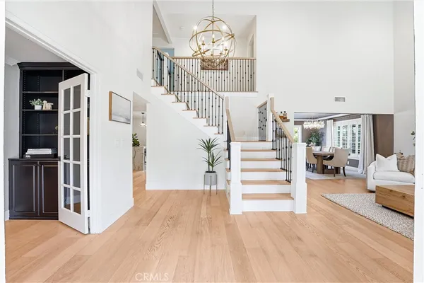 a view of entryway and hall with wooden floor