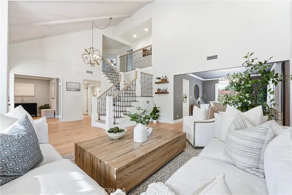 a living room with furniture and a chandelier