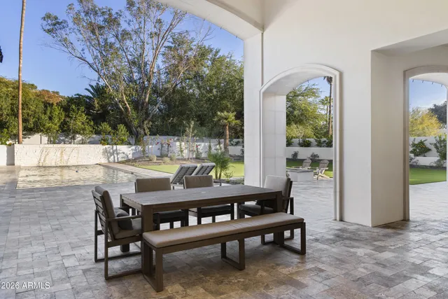 a kitchen with stainless steel appliances granite countertop a sink a stove and cabinets