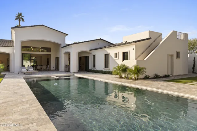a bedroom with a large bed and a balcony