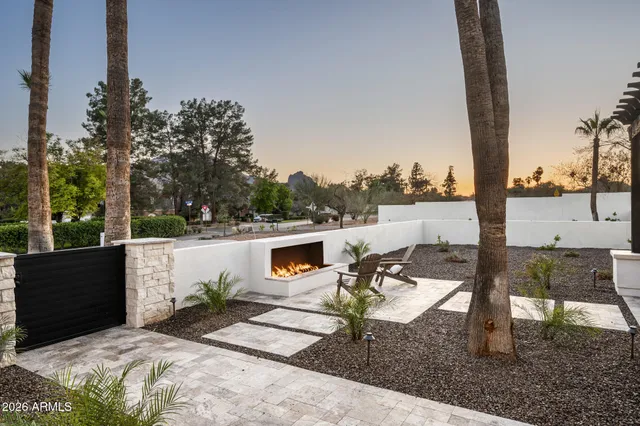 a view of a patio with a table and chairs