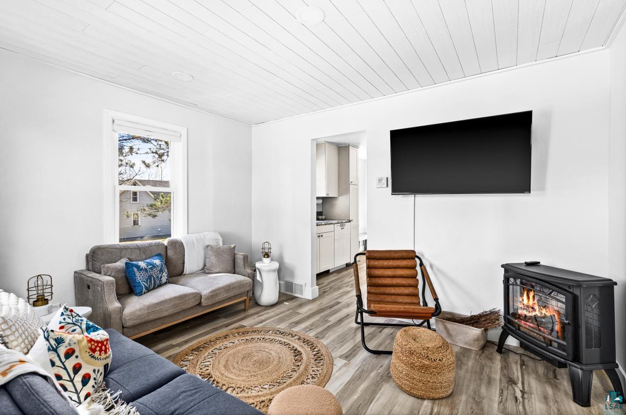 3645 Haines Road Hermantown, MN 55811 - Photo 20 of 35 Living area featuring wood-finish flooring and a white shiplap ceiling