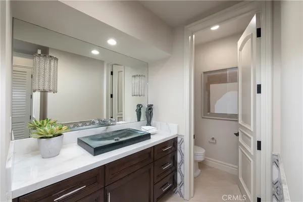 a bathroom with a sink a vanity and a mirror