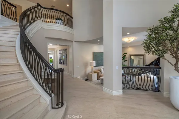 a view of staircase with railing and a chandelier