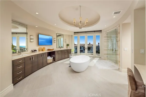 a bathroom with a double vanity sink a toilet a mirror and shower