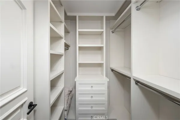 a bedroom with a large bed and ceiling fan