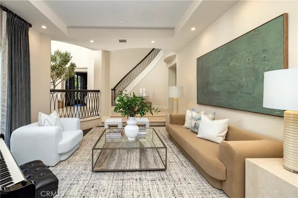 a living room with furniture and a potted plant
