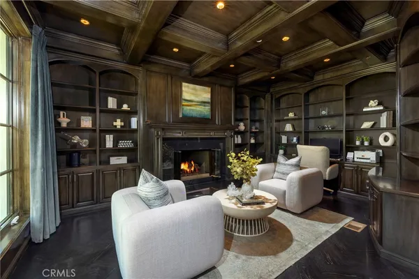 a living room with furniture a fireplace and a chandelier
