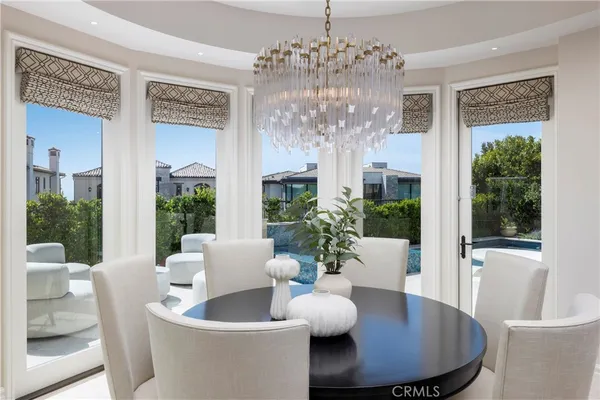 a view of a dining room with furniture wooden floor and chandelier