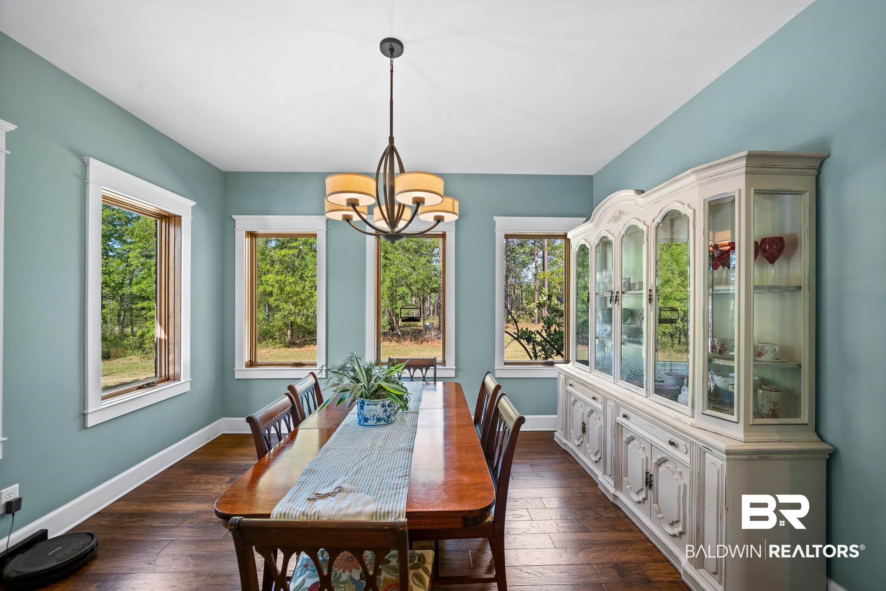 47252 Emmons Road Bay Minette, AL 36507 - Photo 18 of 50 Dining space featuring dark wood-style floors, a chandelier, and healthy amount of natural light