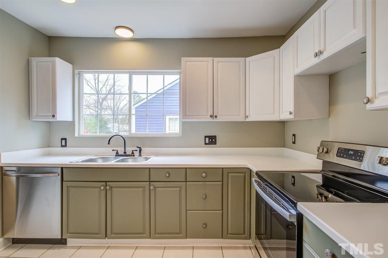 119 South Pettigrew Street Raleigh, NC 27610 - Photo 11 of 30 a kitchen with a sink stove and cabinets