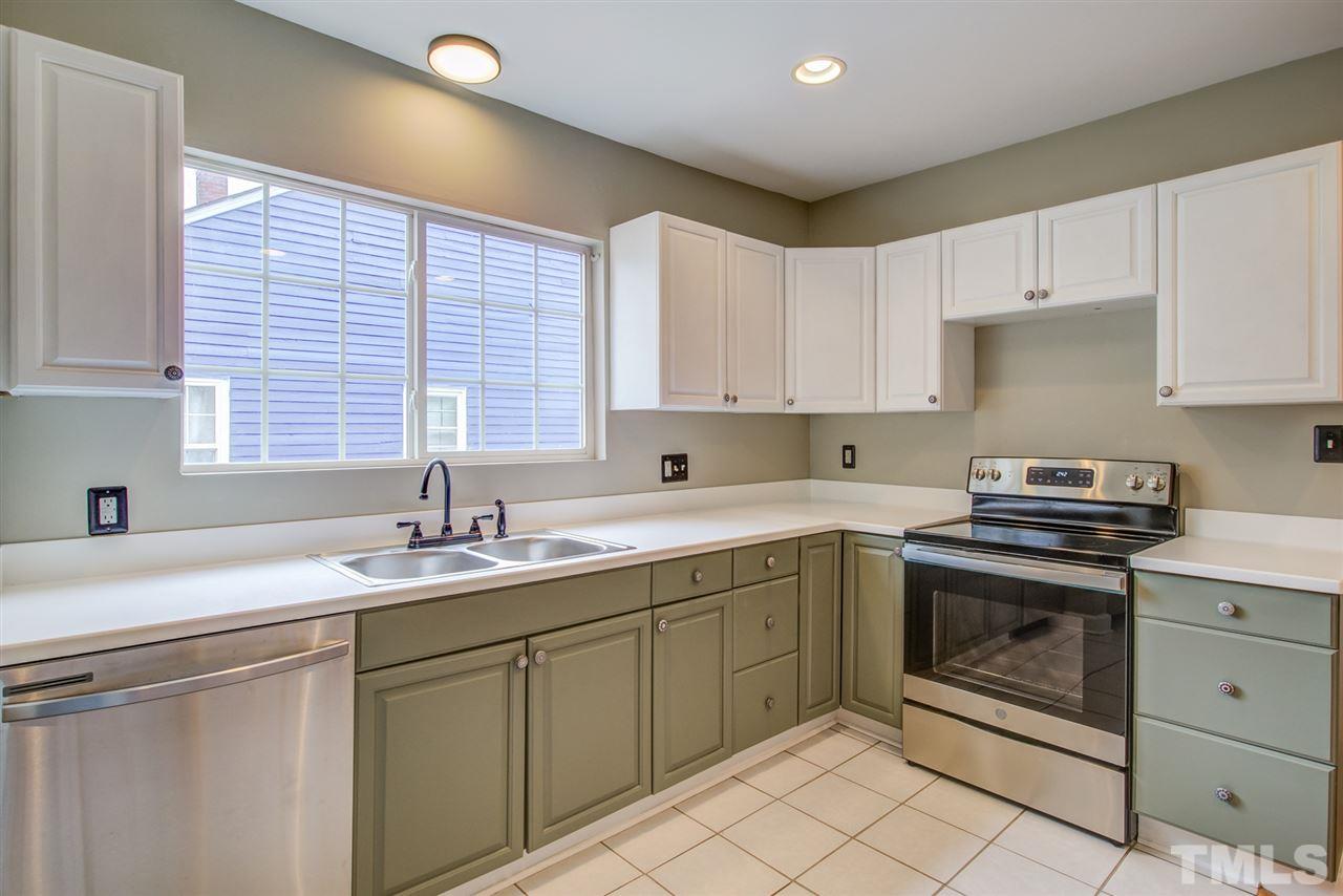 119 South Pettigrew Street Raleigh, NC 27610 - Photo 12 of 30 a kitchen with a sink stove top oven and cabinets