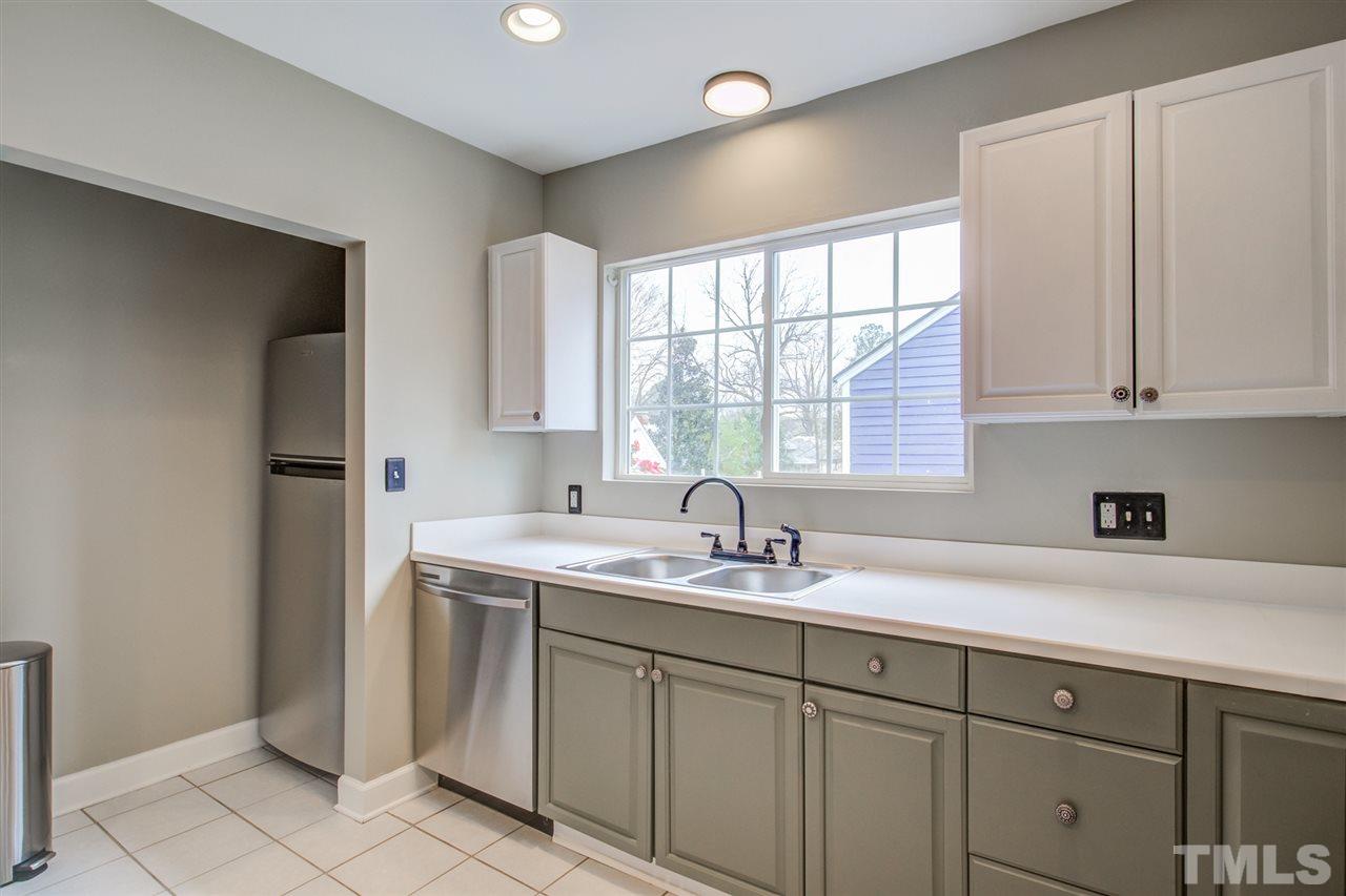 119 South Pettigrew Street Raleigh, NC 27610 - Photo 14 of 30 a kitchen with a sink cabinets and window