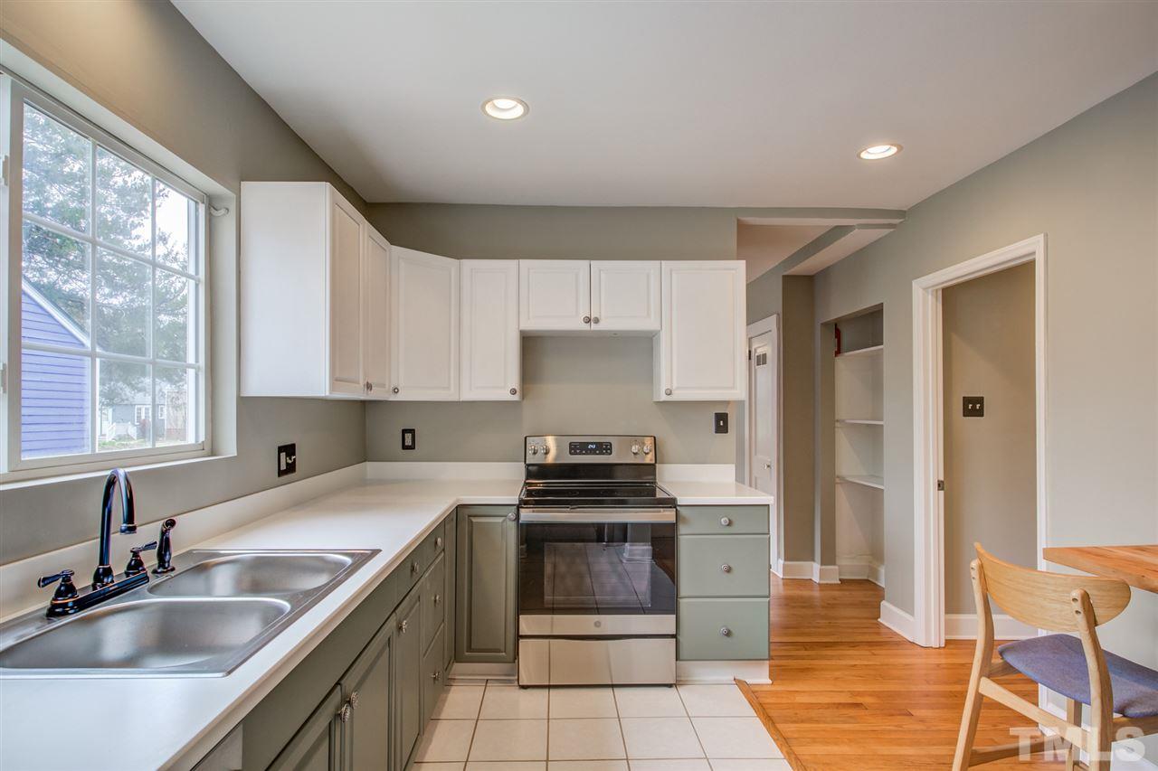119 South Pettigrew Street Raleigh, NC 27610 - Photo 15 of 30 a kitchen with granite countertop a stove sink and refrigerator
