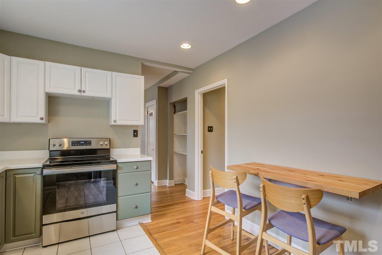 119 South Pettigrew Street Raleigh, NC 27610 - Photo 16 of 30 a kitchen with granite countertop a stove and chairs