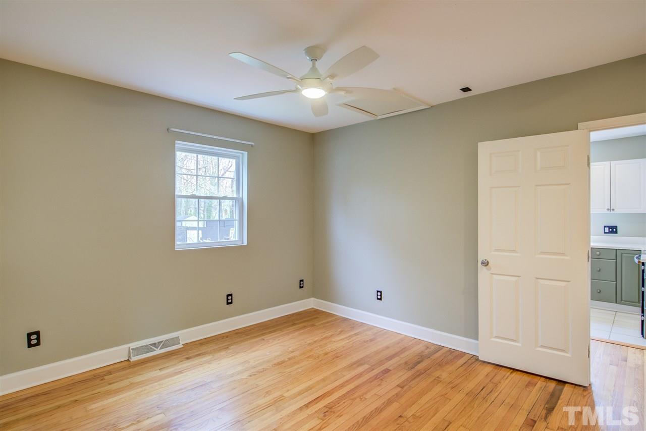 119 South Pettigrew Street Raleigh, NC 27610 - Photo 18 of 30 an empty room with wooden floor and windows