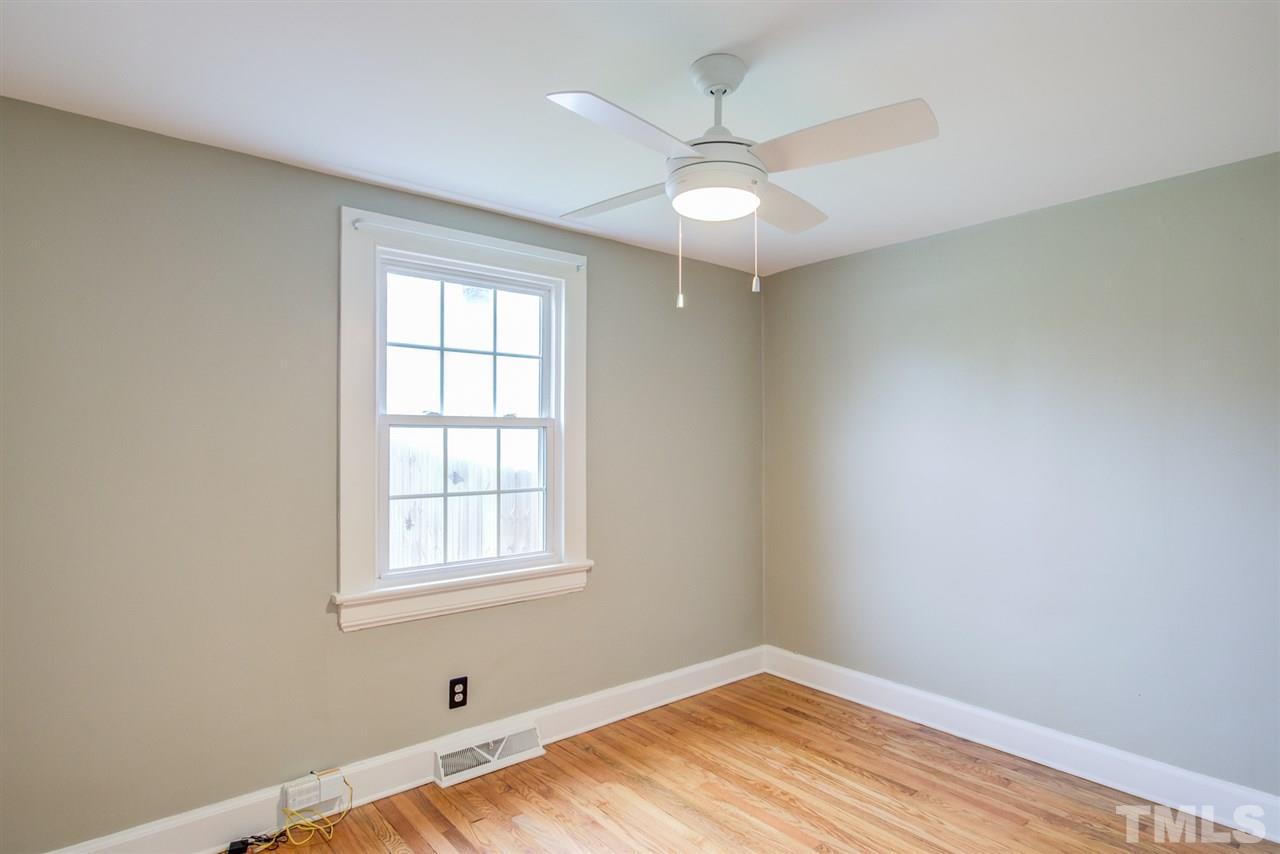 119 South Pettigrew Street Raleigh, NC 27610 - Photo 25 of 30 an empty room with a window and wooden floor