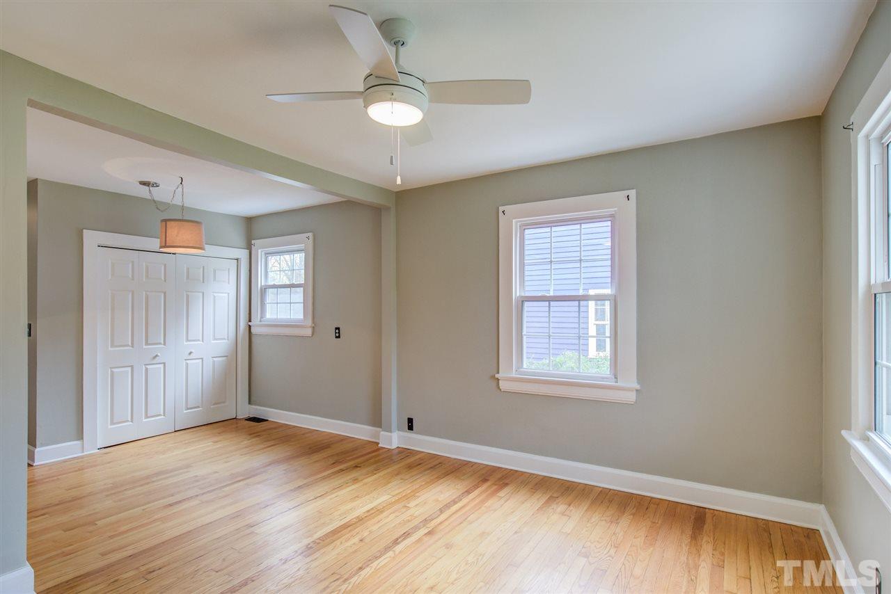 119 South Pettigrew Street Raleigh, NC 27610 - Photo 4 of 30 a view of an empty room with wooden floor and a window