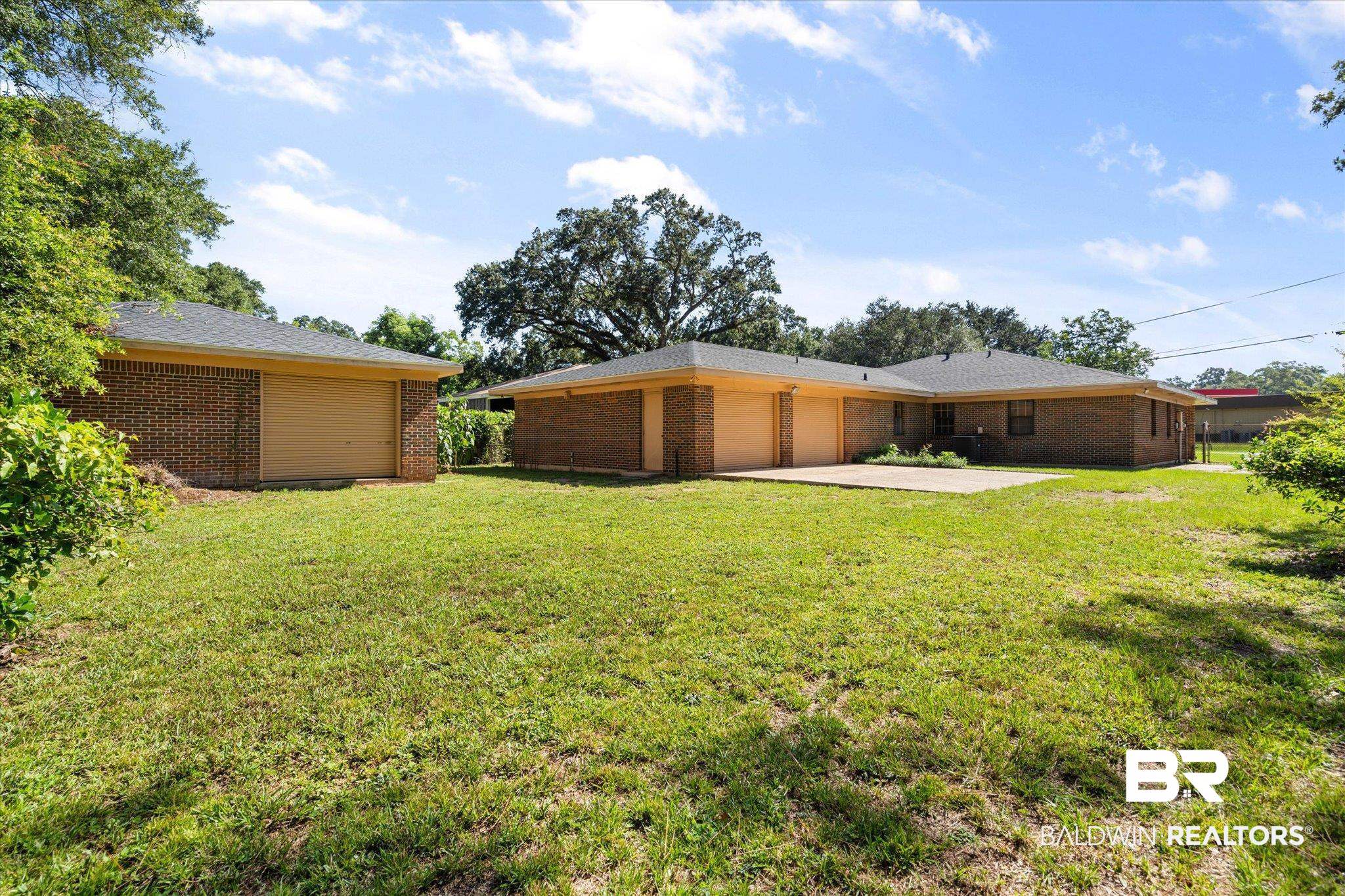 5503 Darring Street Satsuma, AL 36572 - Photo 28 of 31 View of grassy yard featuring a garage and driveway