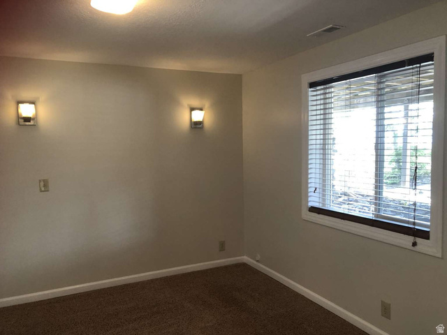 7030 West 2100 North Mendon, UT 84325 - Photo 55 of 67 Carpeted interior space featuring a window with white blinds, white trim, and a dark wood sill