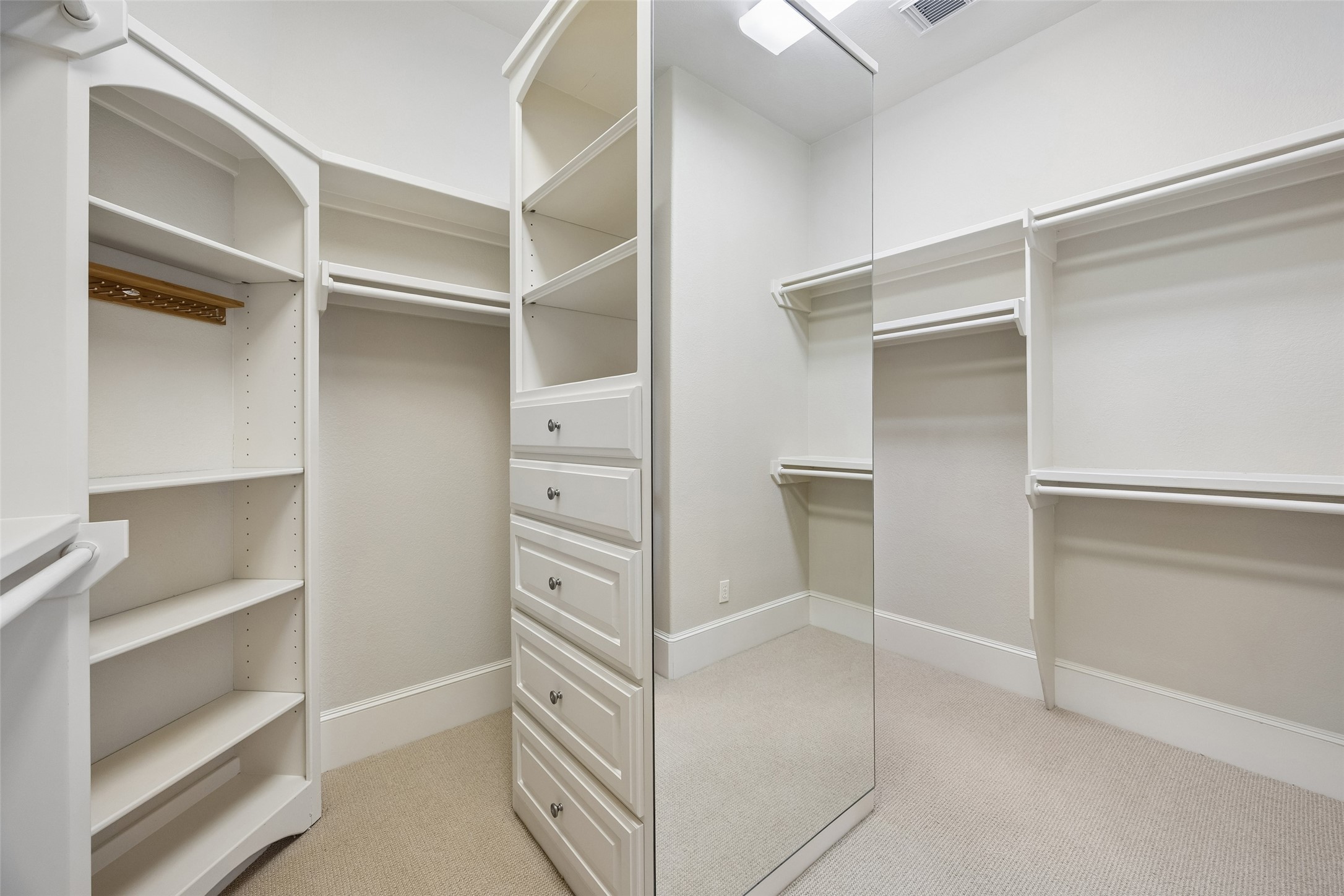 6261 Burgoyne Road Houston, TX 77057 - Photo 27 of 40 Spacious walk-in closet with ample shelving, built-in drawers, and hanging space.