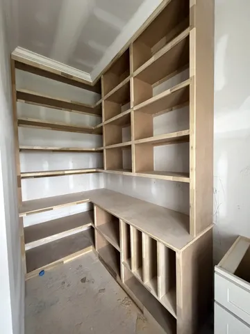 a view of an empty room with a kitchen