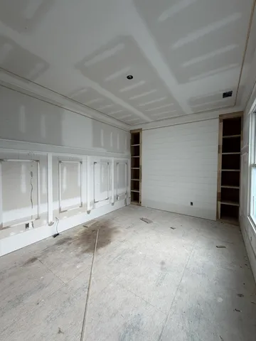 a view of empty room with a projector