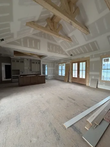 a living room with furniture and large windows