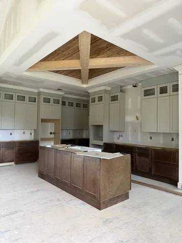 a view of an empty room with stairs and furniture