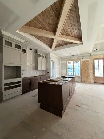a living room with furniture and large windows