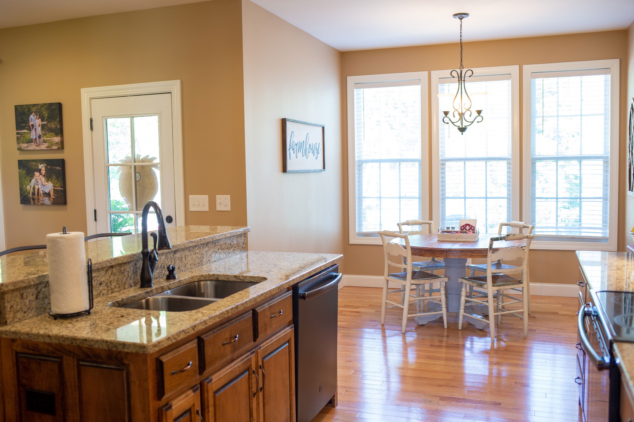 310 Freeland Road Portland, TN 37148 - Photo 12 of 31 a kitchen with granite countertop a dining table chairs and white cabinets