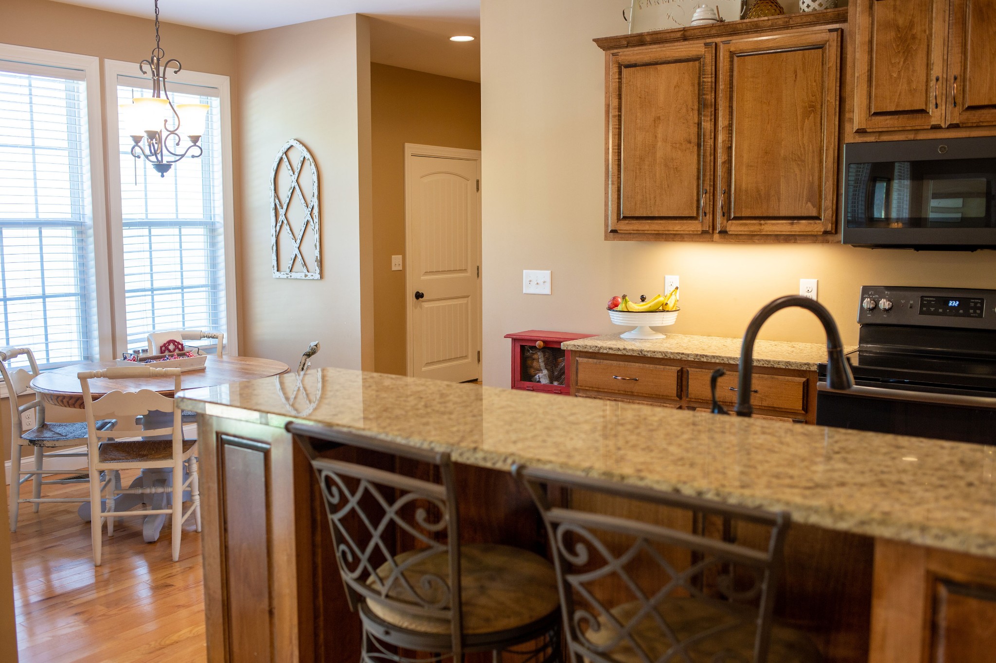310 Freeland Road Portland, TN 37148 - Photo 14 of 31 a kitchen with stainless steel appliances granite countertop a table chairs sink and stove