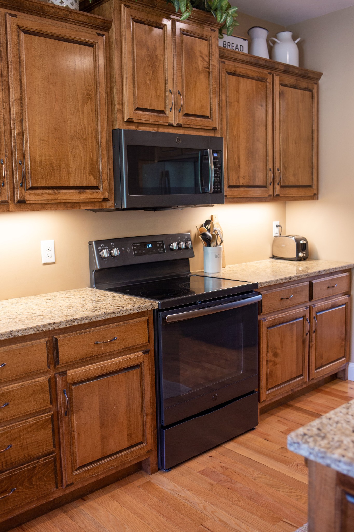 310 Freeland Road Portland, TN 37148 - Photo 15 of 31 a kitchen with granite countertop a stove top oven microwave and cabinets