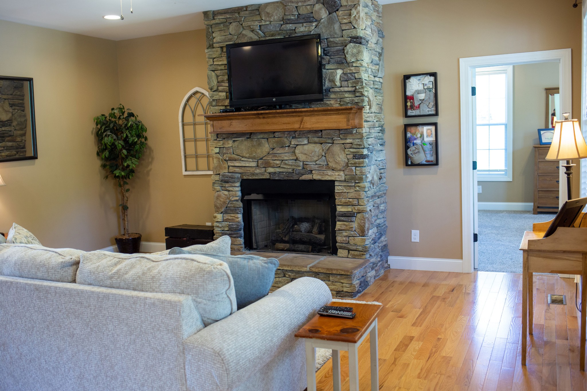 310 Freeland Road Portland, TN 37148 - Photo 18 of 31 a living room with furniture a flat screen tv and a fireplace
