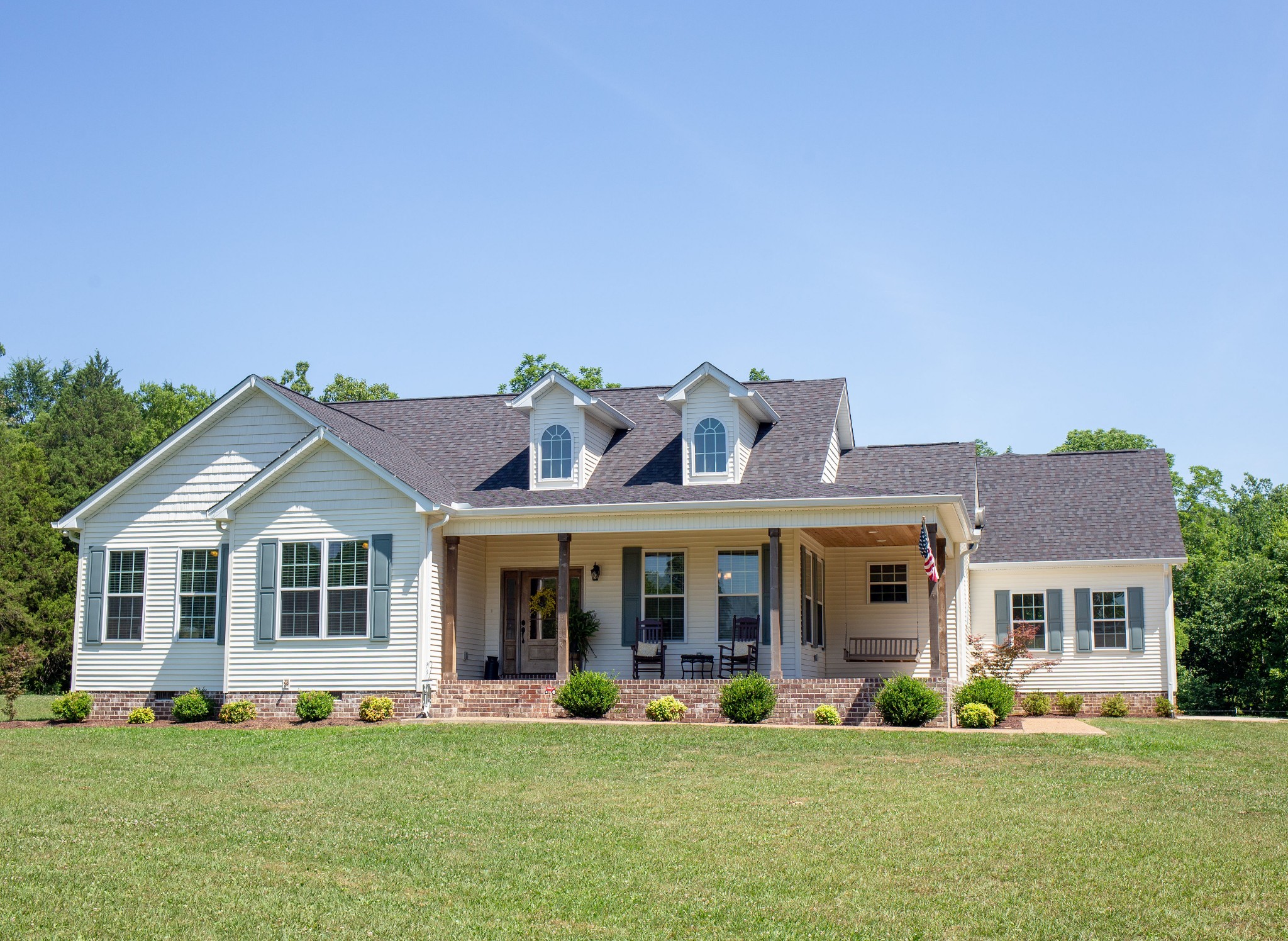 310 Freeland Road Portland, TN 37148 - Photo 3 of 31 a front view of a house with a garden and porch