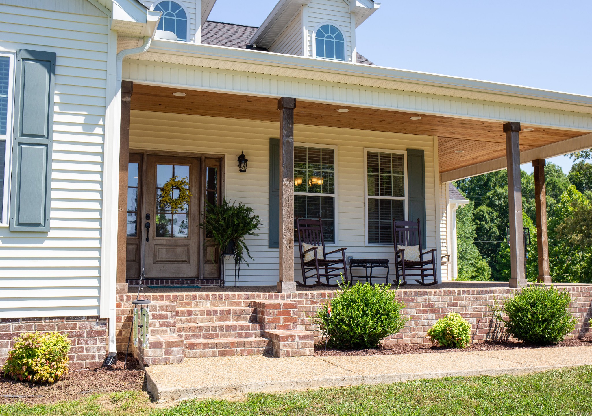 310 Freeland Road Portland, TN 37148 - Photo 5 of 31 a front view of a house with outdoor seating and a potted plant
