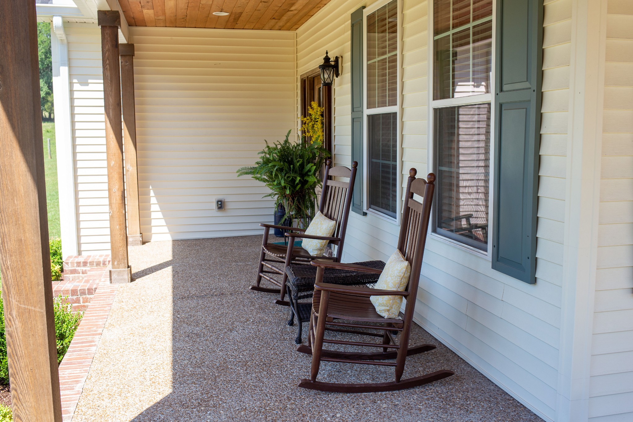 310 Freeland Road Portland, TN 37148 - Photo 7 of 31 a porch with a chair and potted plant on a table