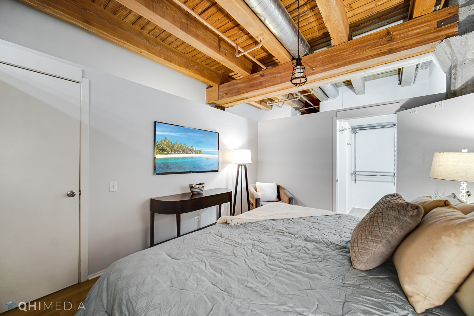 333 South Desplaines Street, Unit 314 Chicago, IL 60661 - Photo 16 of 22 a bedroom with a bed and a lamp on dresser