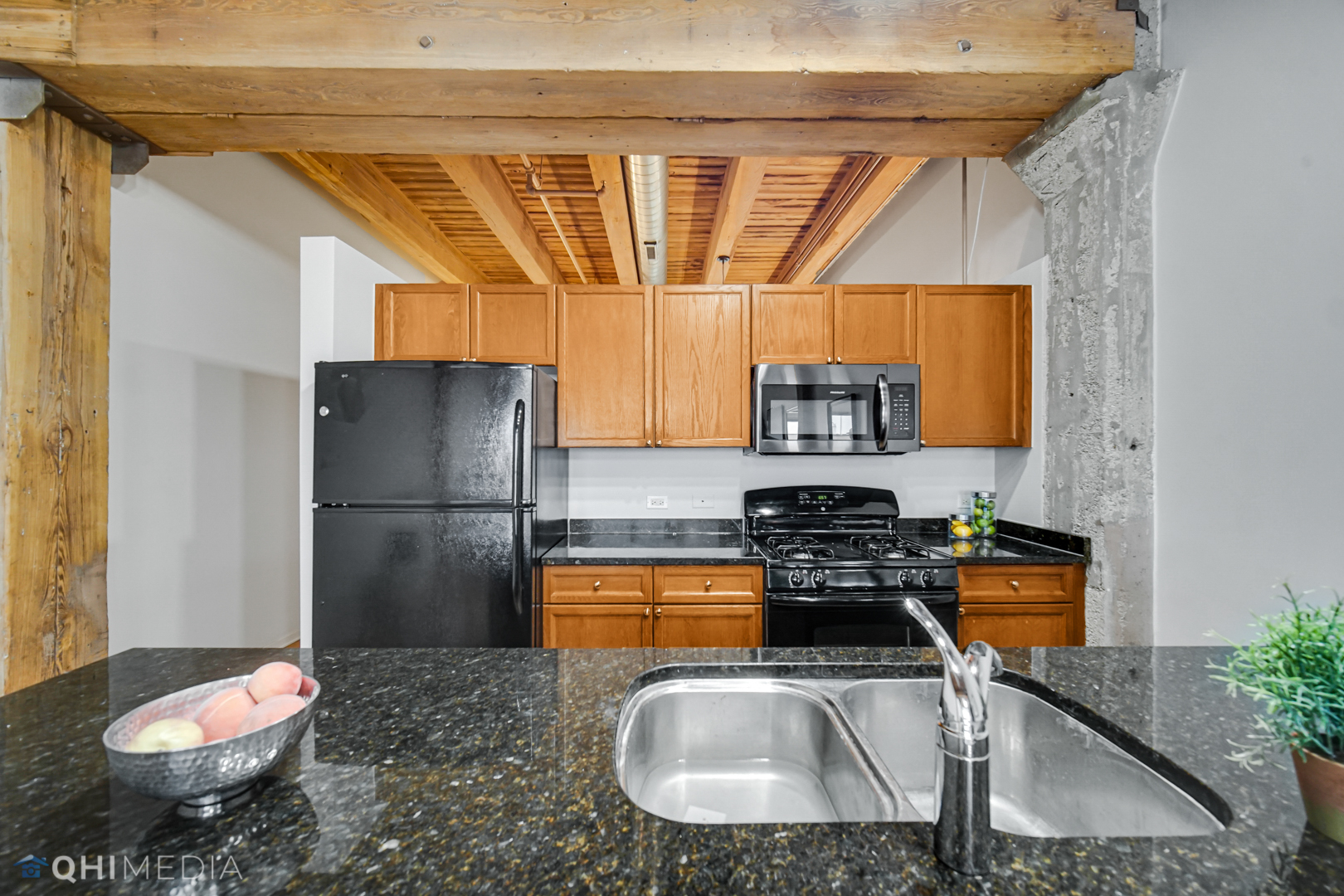 333 South Desplaines Street, Unit 314 Chicago, IL 60661 - Photo 6 of 22 a kitchen with a refrigerator a stove a washer and dryer