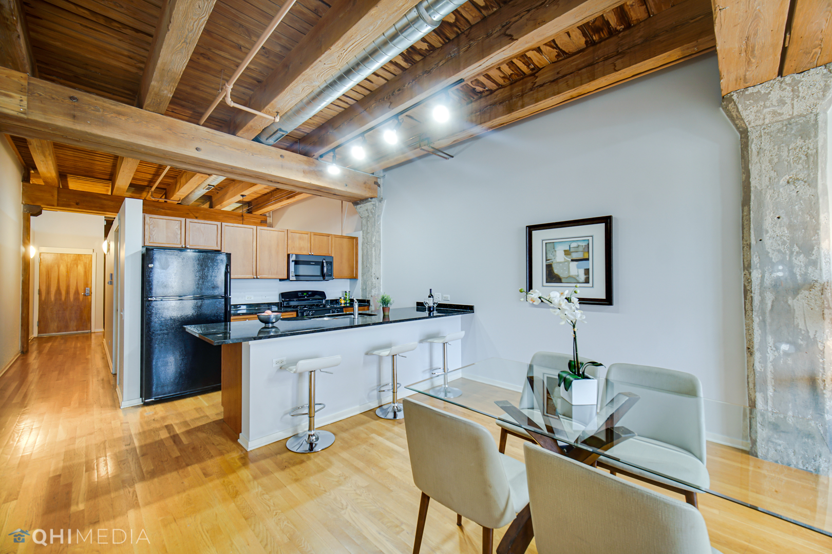 333 South Desplaines Street, Unit 314 Chicago, IL 60661 - Photo 9 of 22 a kitchen with stainless steel appliances granite countertop a sink a stove and a refrigerator