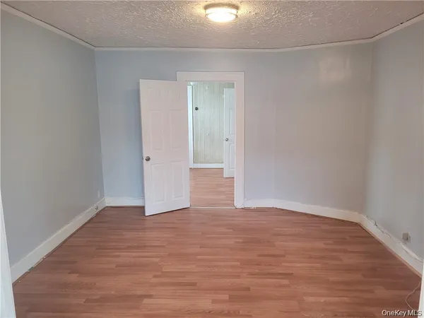 a view of an empty room and wooden floor